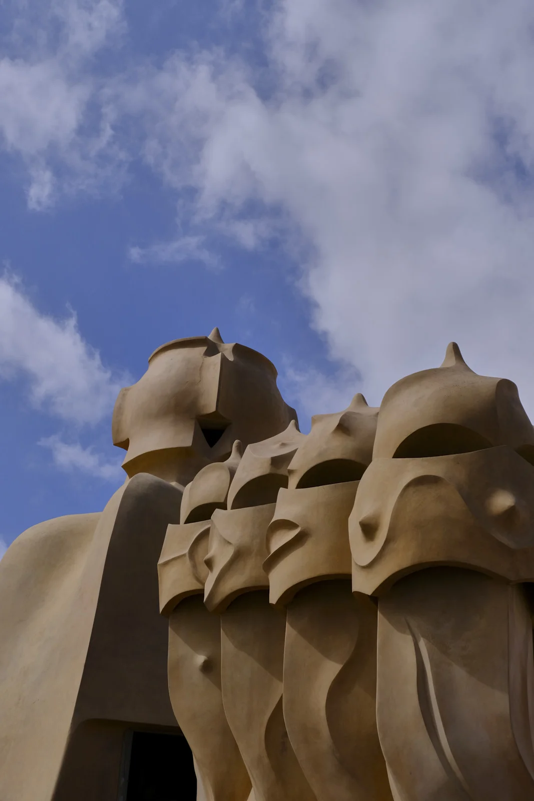 Sculpted chimney pots cluster on the roof of La Pedrera in Barcelona.