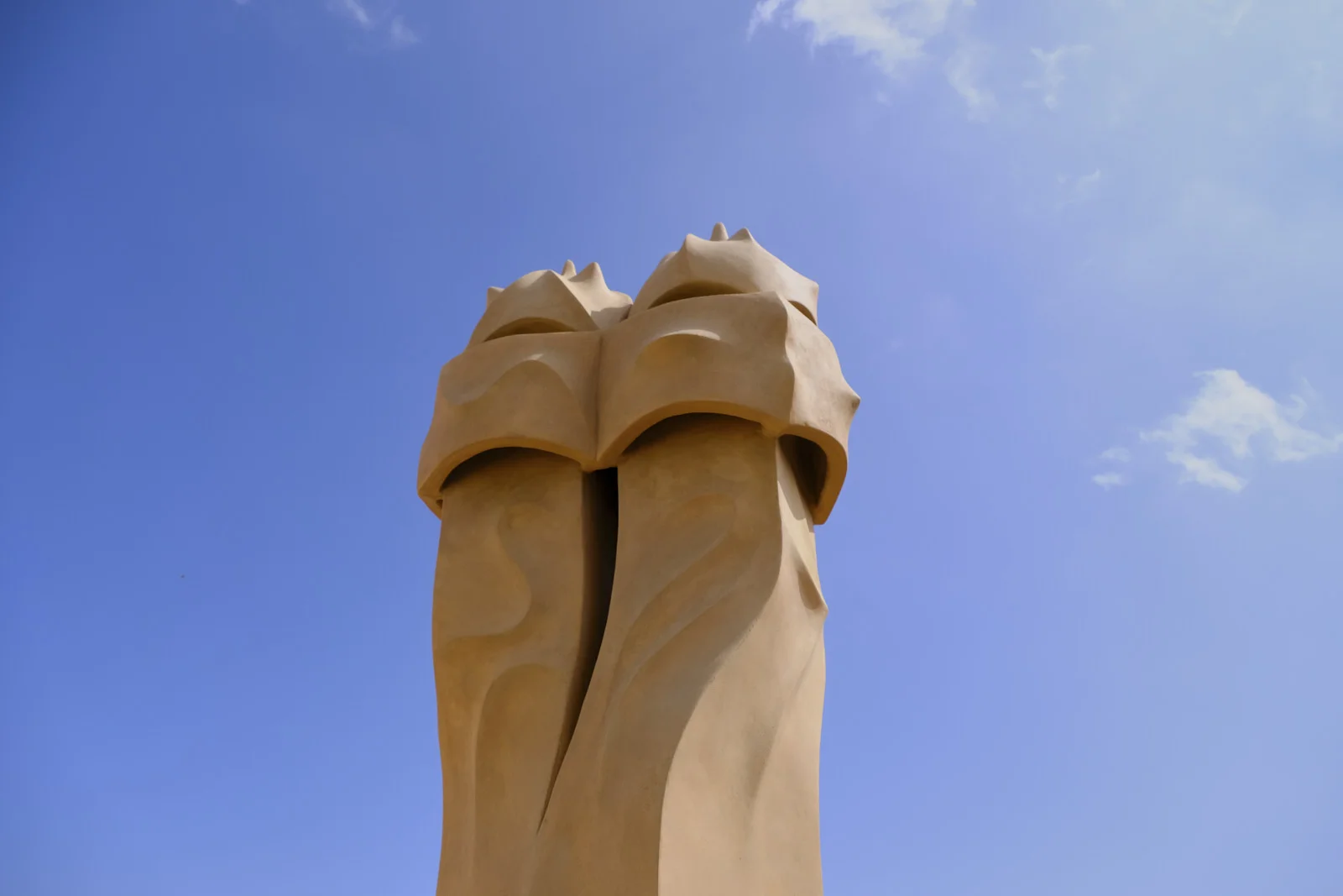 Two joined chimney pots stand on the roof of La Pedrera in Barcelona.