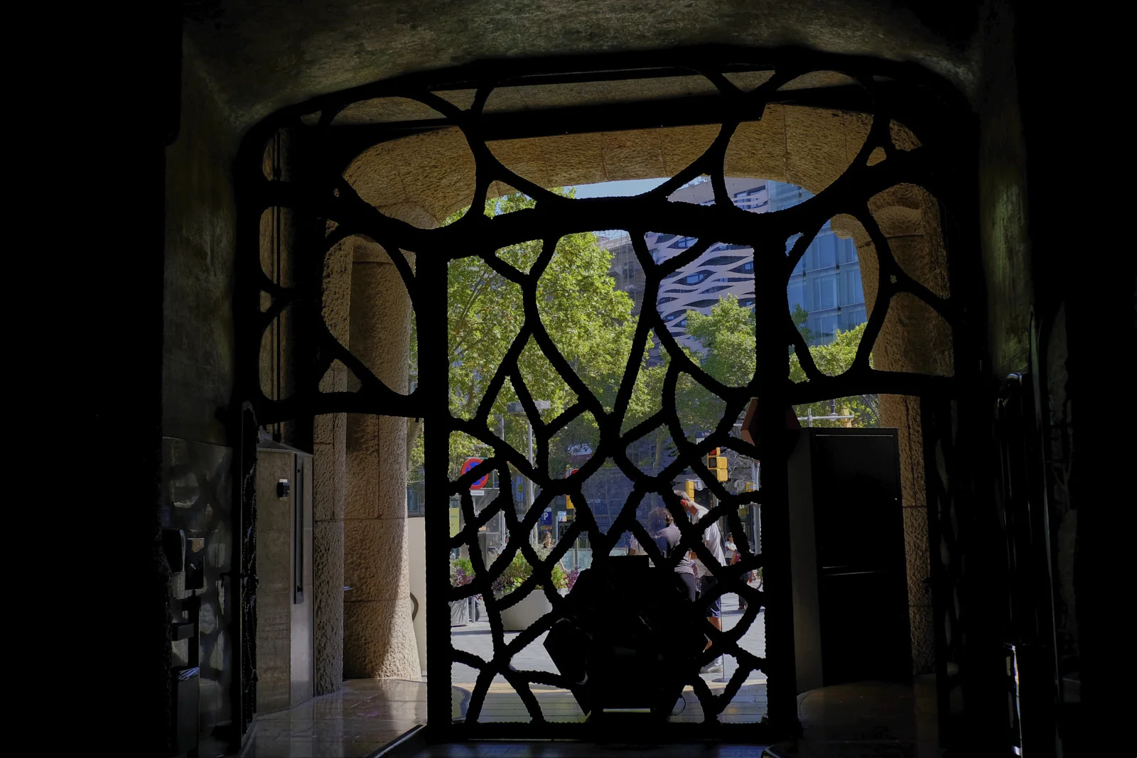 The iron entrance gate of La Pedrera in Barcelona opens from the interior onto the street.