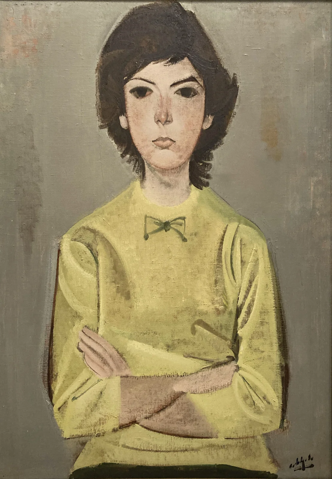 A painting of a woman with her arms crossed hangs on a wall in Zaragoza.