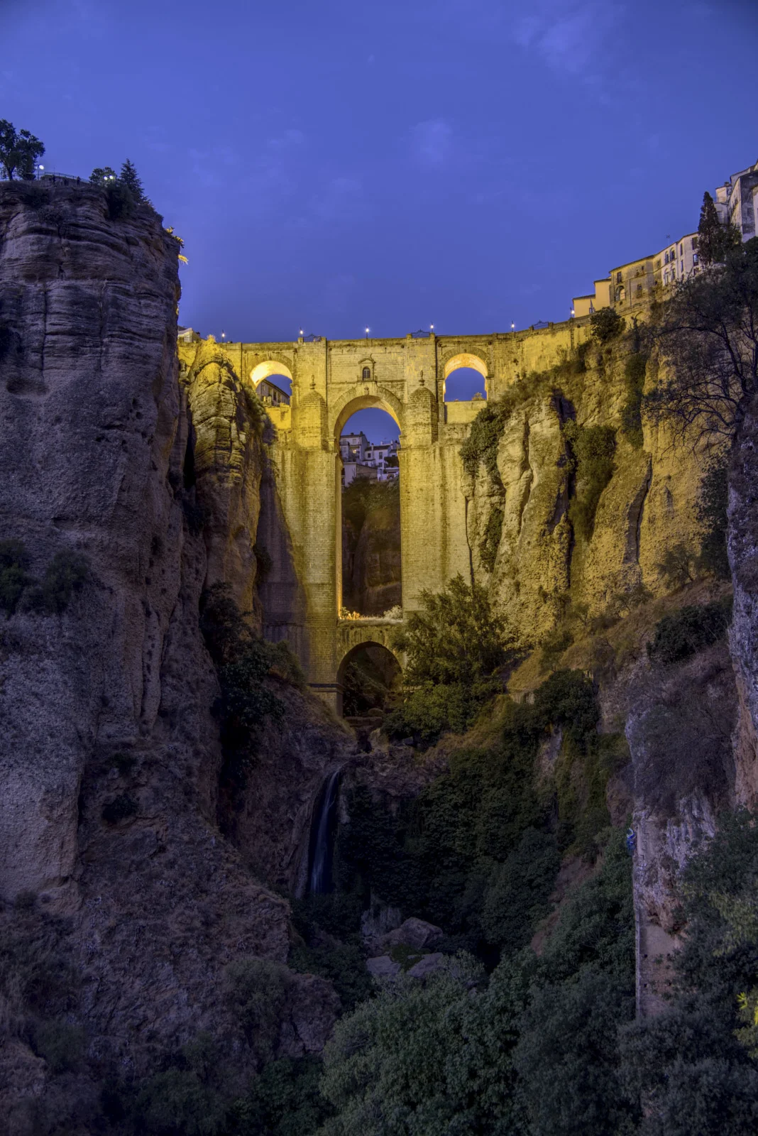 Puente Nuevo at Ronda has a large central arch over El Tajo and a smaller arch below, with a waterfall in the gorge.